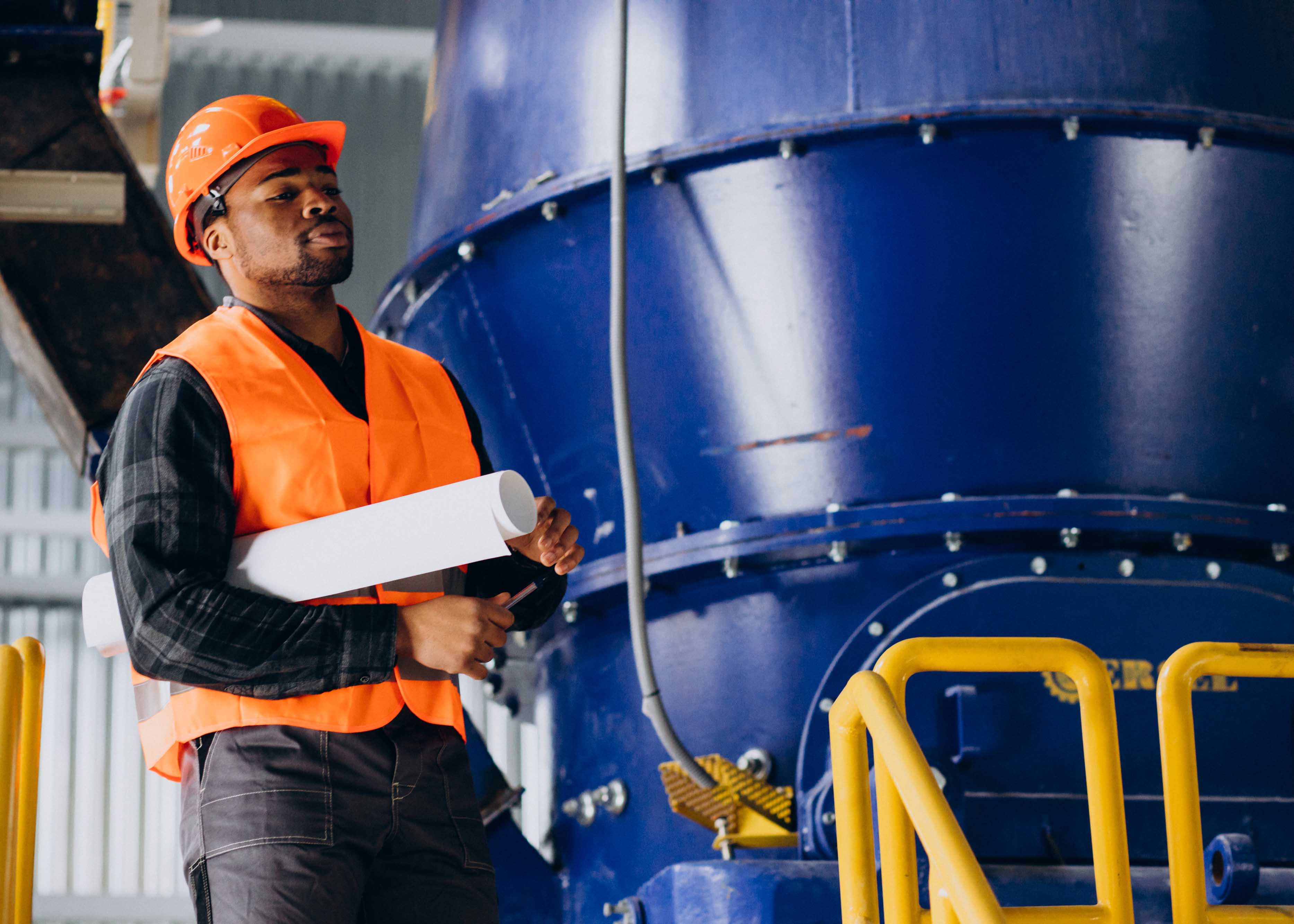 Safety officer speaking on phone near fuel trucks
